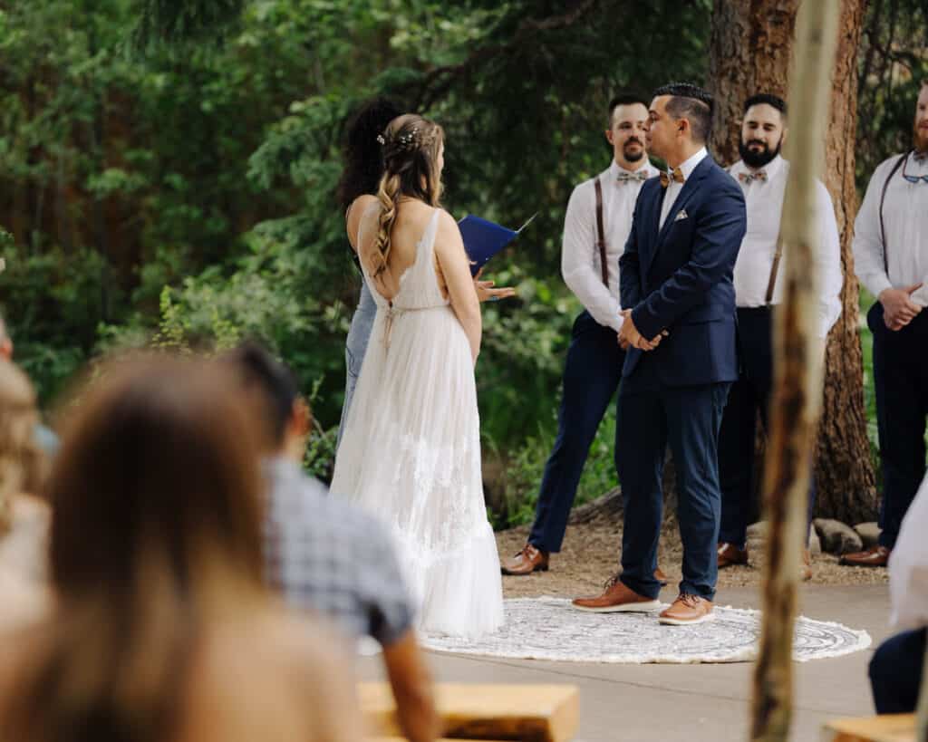 Bride and groom stand for their vows during the Ceremony at Blackstone Rivers Ranch in Idaho Springs