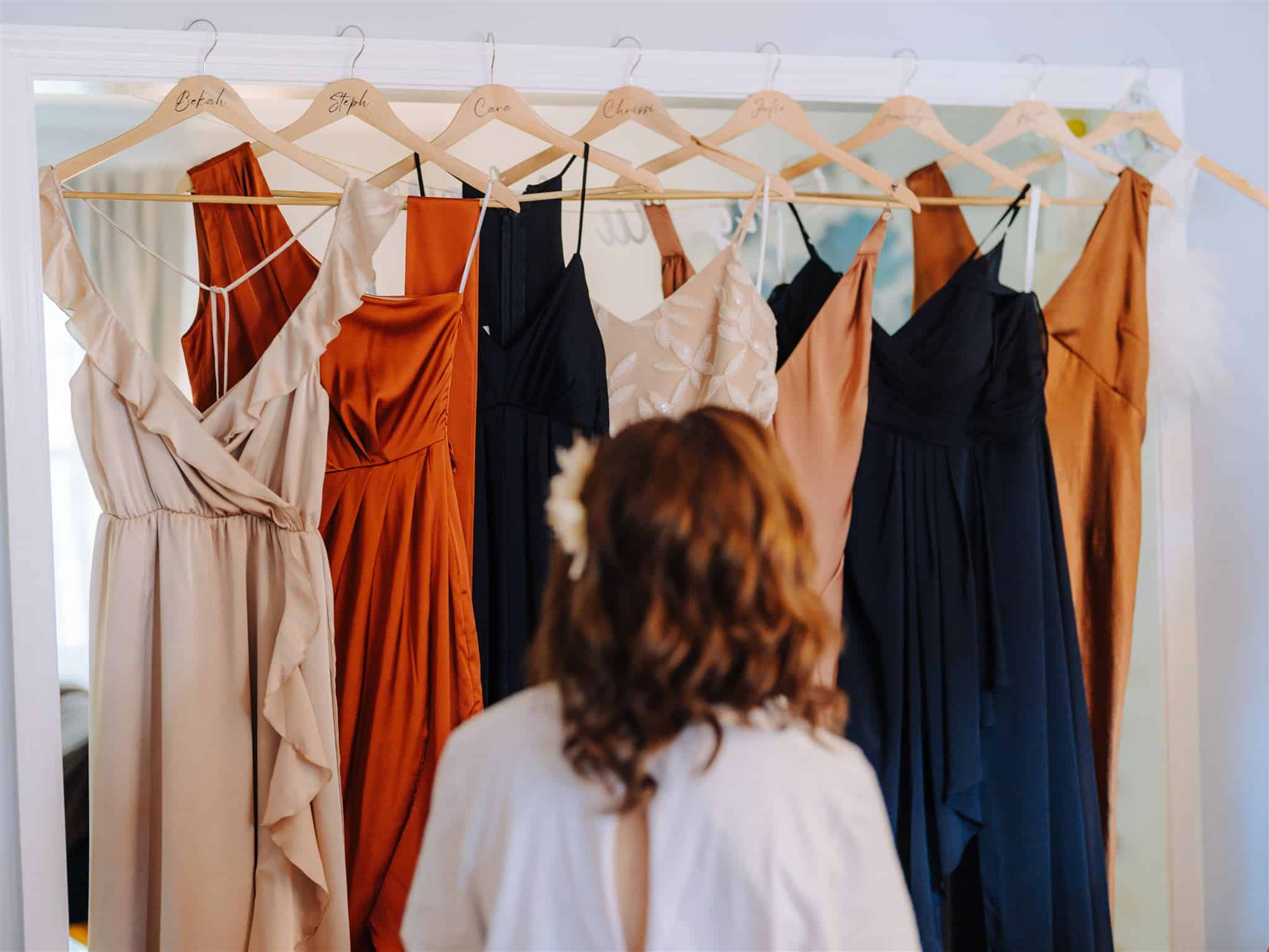 bridesmaids dresses handing on wood hangers