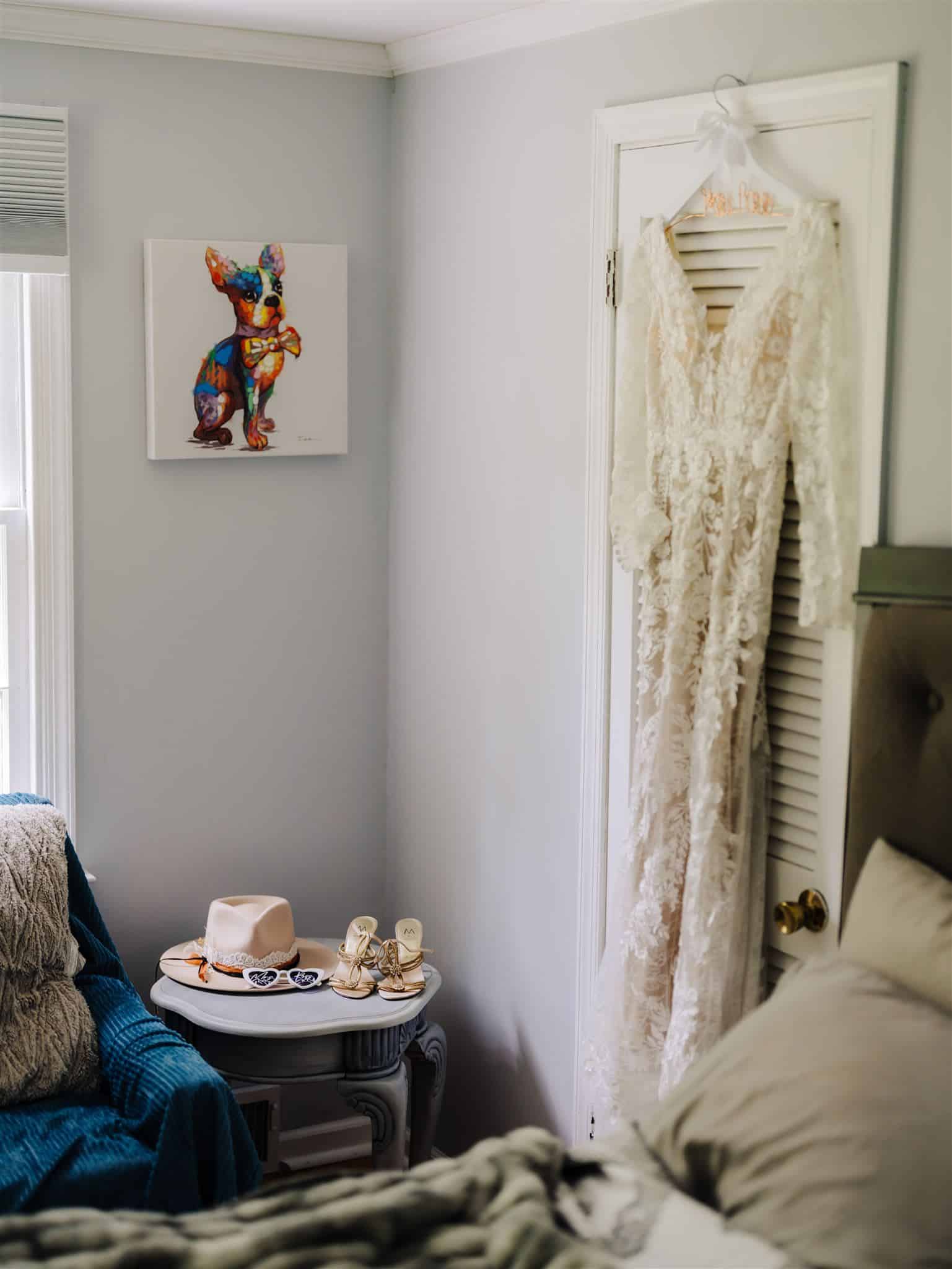 bride dress hanging with fedora