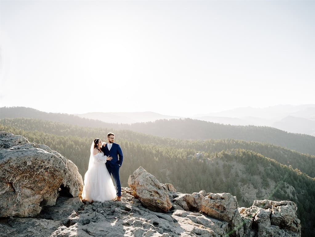 Couple eloping at Lost Gulch Overlook in Boulder, Colorado, standing on rocky cliffs with sweeping mountain views during golden hour.