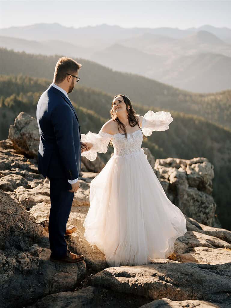 Bride and groom exchanging vows on rocky overlook at Lost Gulch Boulder Colorado mountain elopement with sunset light