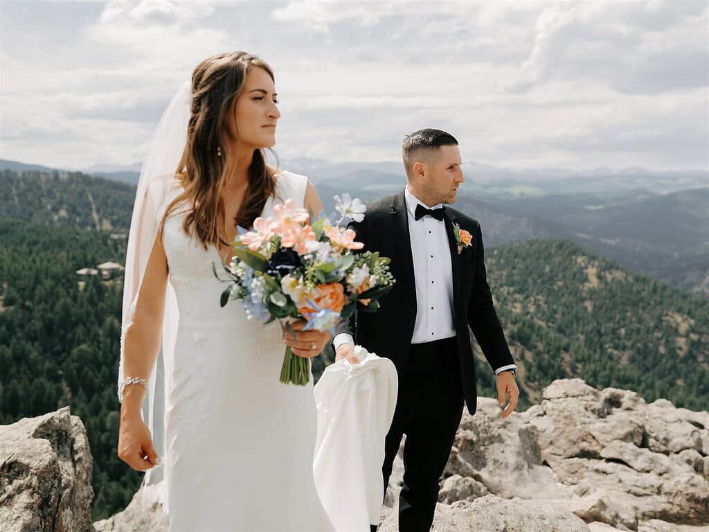 Newlywed couple walking on granite rocks at Lost Gulch Overlook after Boulder Colorado elopement ceremony