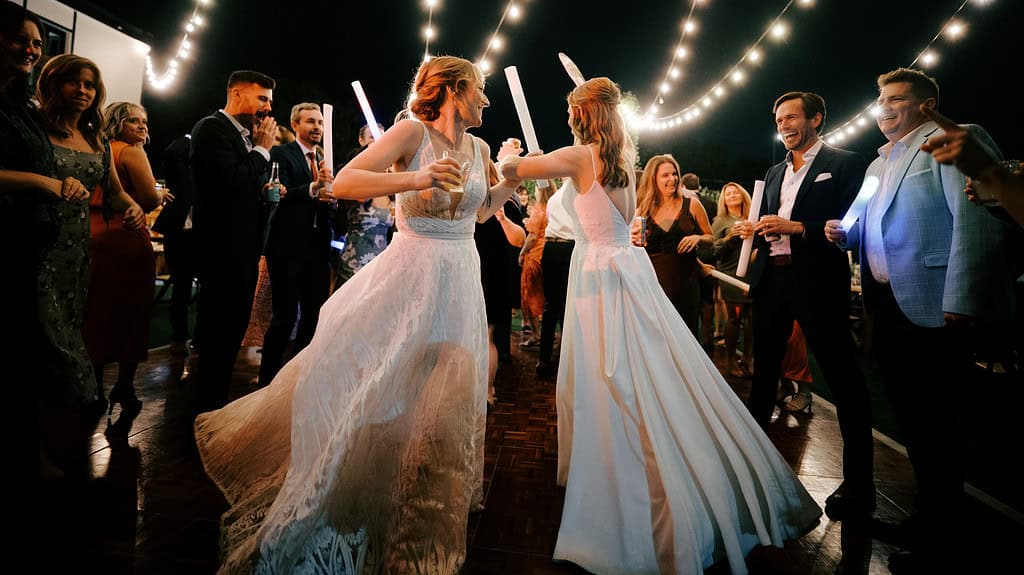 two brides on their wedding party on the dance floor at Mountain Crust in Denver Colorado