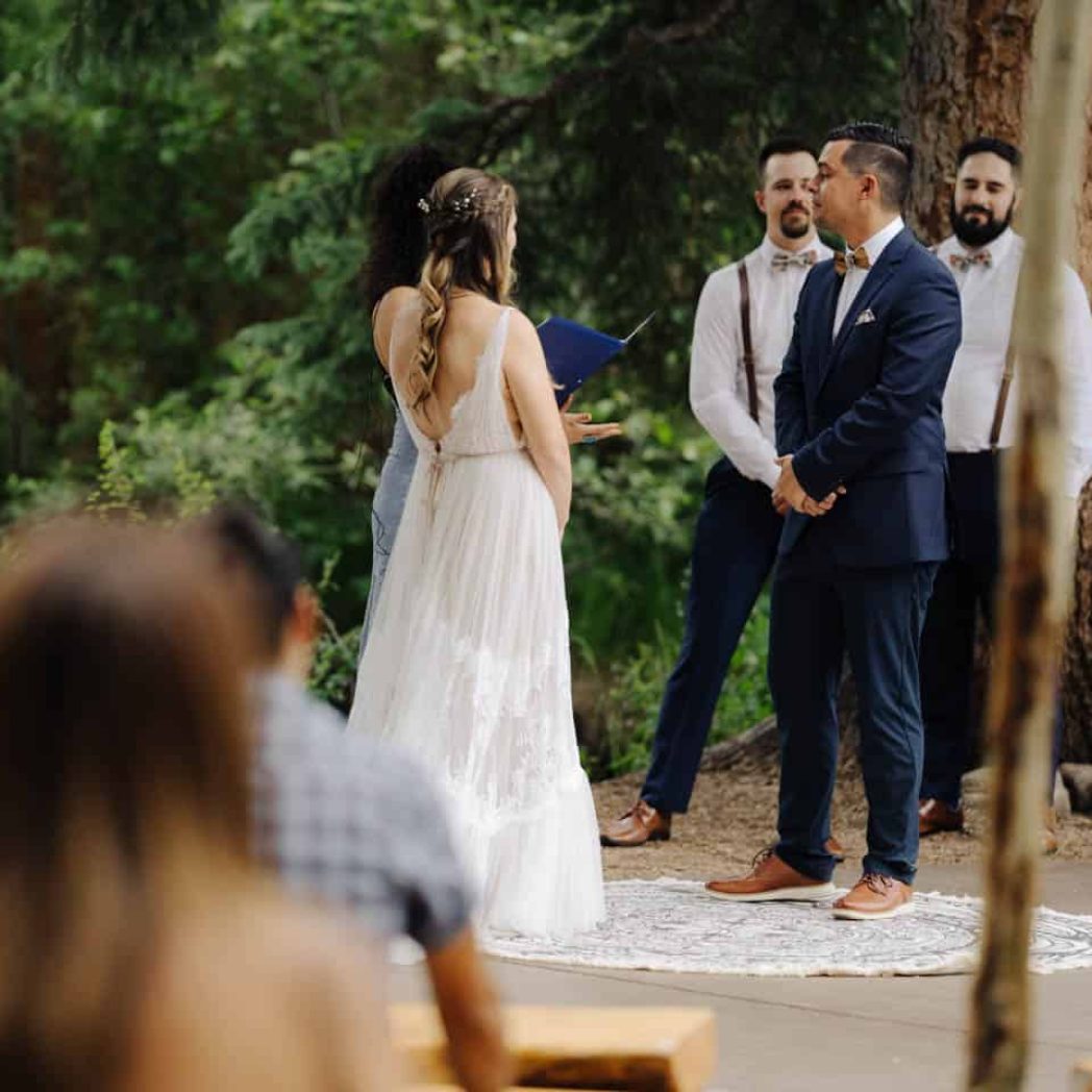 Bride and groom stand for their vows during the Ceremony at Blackstone Rivers Ranch in Idaho Springs